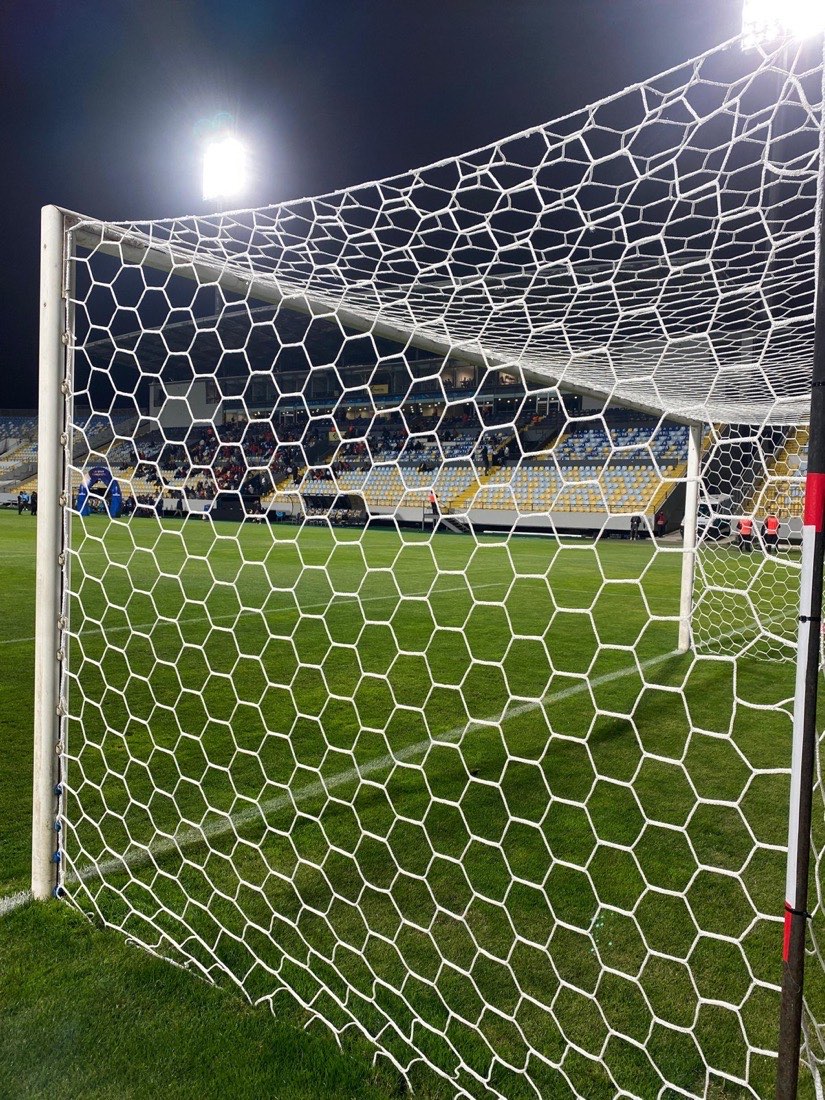 Malla hexagonal de arco profesional en estadio, partido nocturno